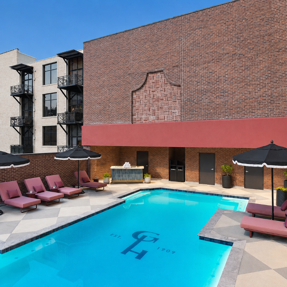Outdoor pool at The Gunter Hotel with lounge chairs and brick courtyard in downtown San Antonio