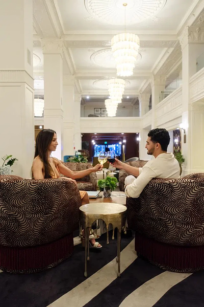 Champagne toast for two celebrating The Gunter Hotel's Tribute Portfolio transformation
