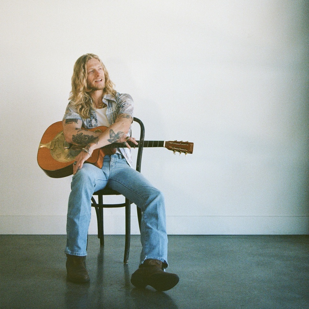 Jordan Matthew Young with an acoustic guitar, opening for Tomar & The FCs in San Antonio