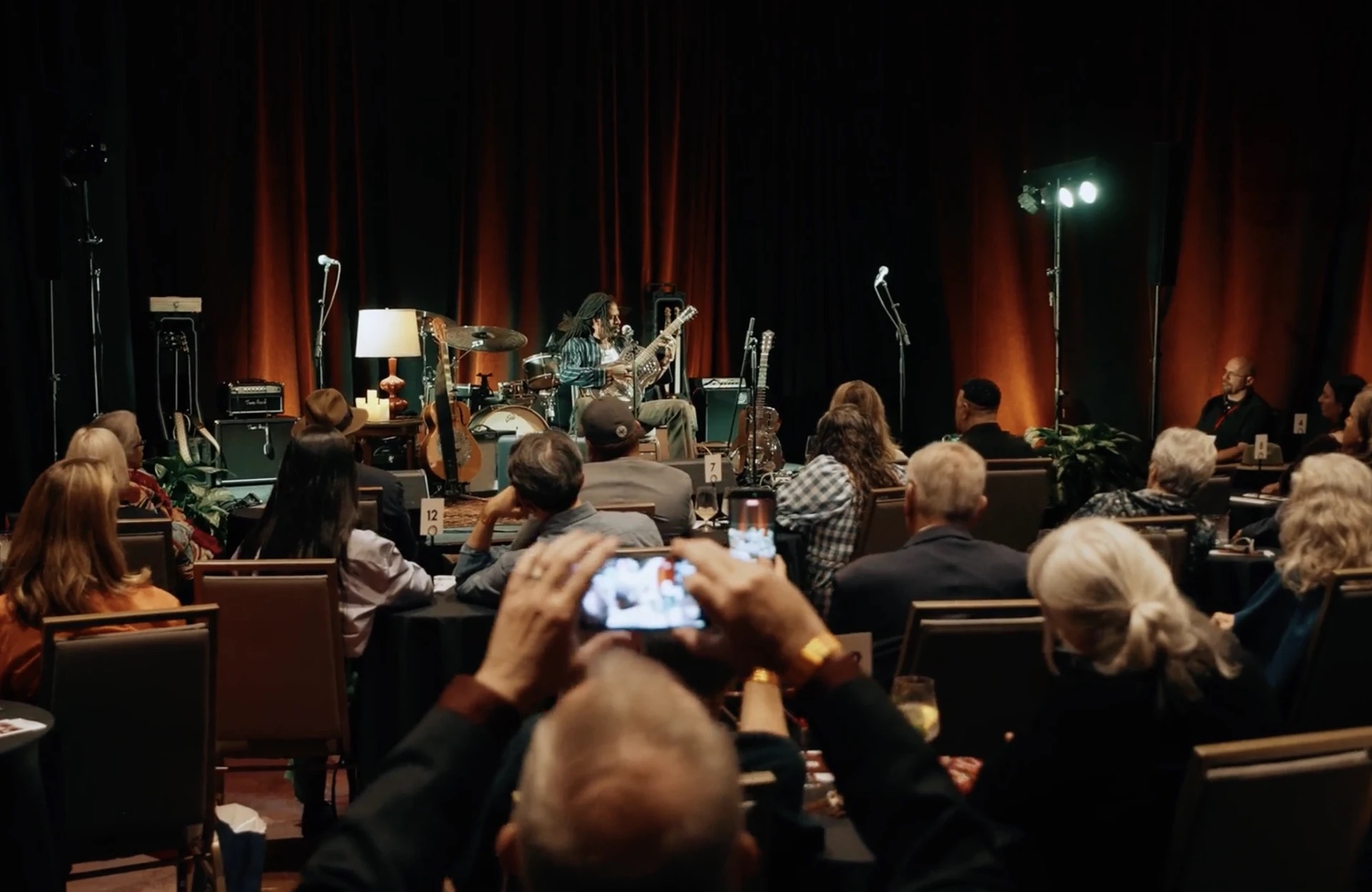 Musician performing live for a seated audience during the Robert Johnson 90th Anniversary Weekend at The Gunter Hotel