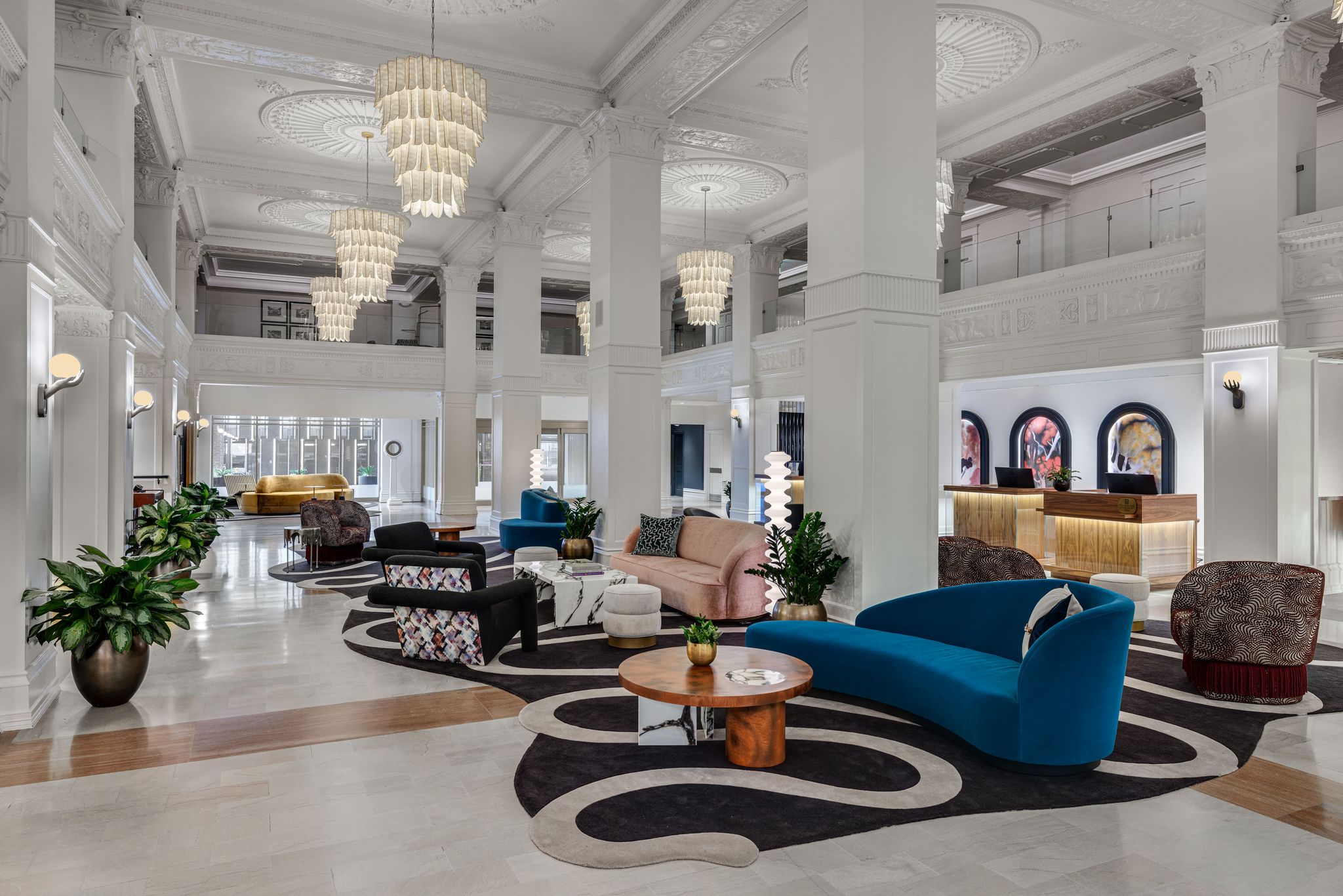 a large lobby with a large chandelier and couches